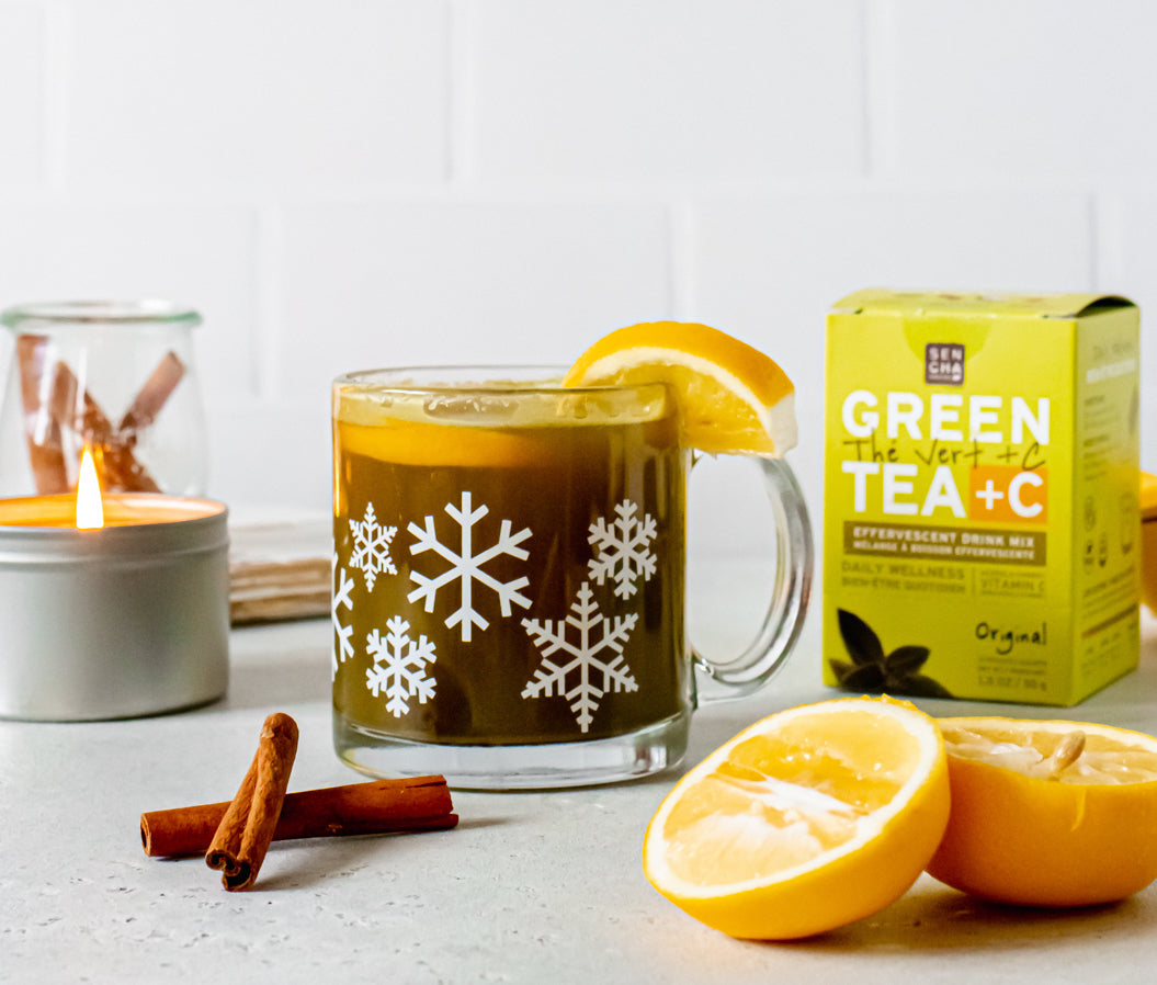 Glass mug of green tea with lemon, cinnamon sticks, and Sencha green tea vitamin C drink mix