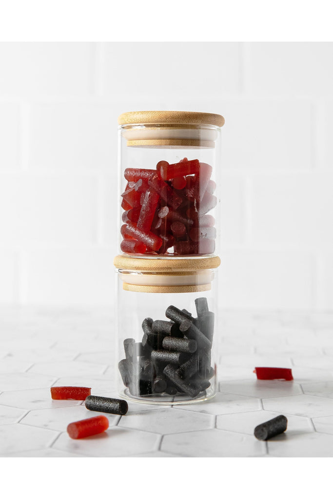 Licorice and Fruit Mix Bites in Jars with Background